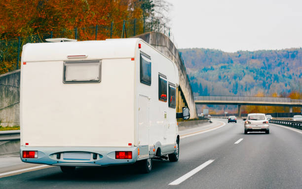 istock White Camper rv in road on highway 1219786200