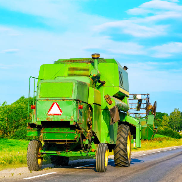 Combine harvester harvesting wheat on a sunny summer day.