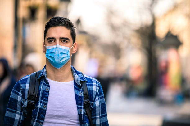 istock Man covering his face with pollution mask for protection from viruses 1219789195