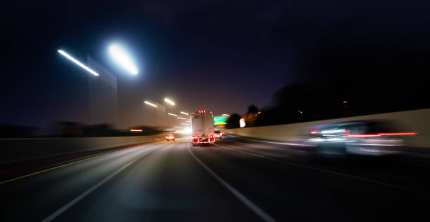istock Semi truck speeding at night with much need help 1219789560