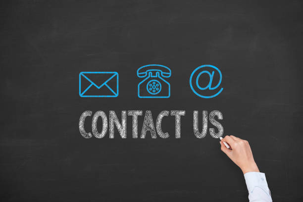 istock Human Hand Drawing Contact Us on Blackboard 1219790740