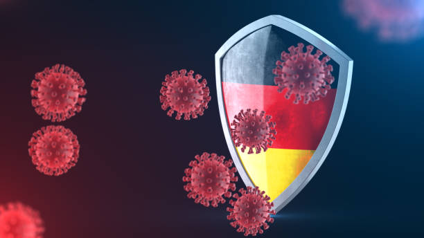 istock Security shield as virus protection concept. Coronavirus Sars-Cov-2 safety barrier. Shiny steel shield painted as German national flag defend against cells, source of covid-19 disease. 3D rendering 1219791835
