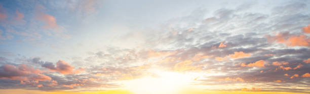 istock Blue sky clouds background. Beautiful landscape with clouds and orange sun on sky 1219791884