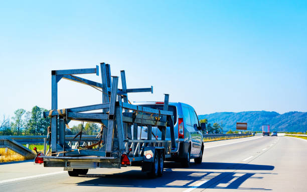 istock Mini van carrying trailer on asphalt road in Slovenia 1219791891
