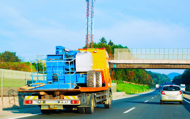 Mobile crane on highway road in Slovenia Low tow truck trailer with car in road. Auto vehicle with Carrier transporter hauler on driveway. European transport logistics at haulage work transportation. Haul on highway. Hauling Trailers for heavy construction machineries stock pictures, royalty-free photos & images