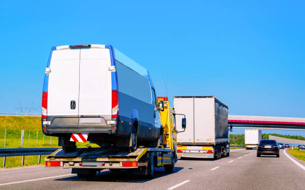 Tow truck transporter carrying mini van in Road in Slovenia Low tow truck trailer with Minivan car in road. Mini van auto vehicle with Carrier transporter hauler on driveway. European transport logistics at haulage work transportation. Haul on highway. car carrier semi stock pictures, royalty-free photos & images