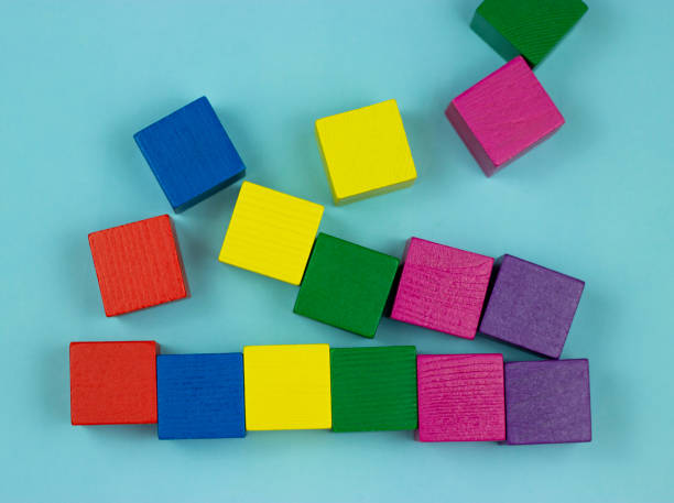 istock colorful wooden cubes scattered on a blue background 1219792205