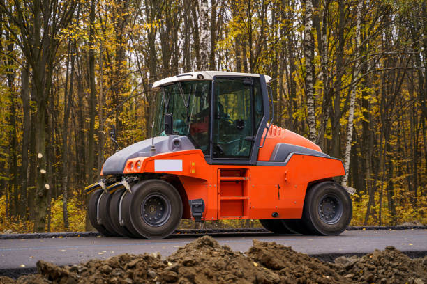 Pavement truck. Laying fresh asphalt on construction site.
