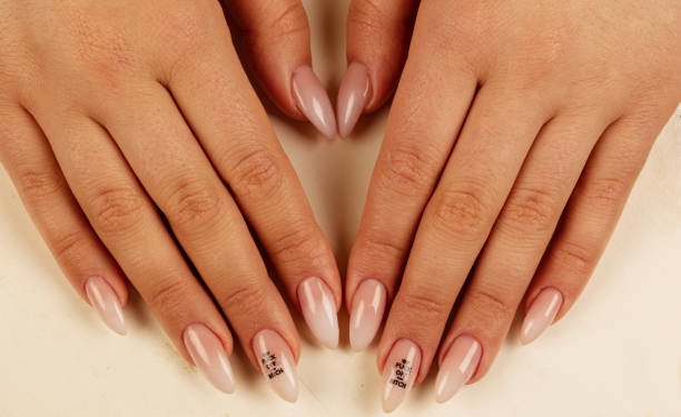 istock Close-up nail polish and long nails. Perfect manicure. 1219792320