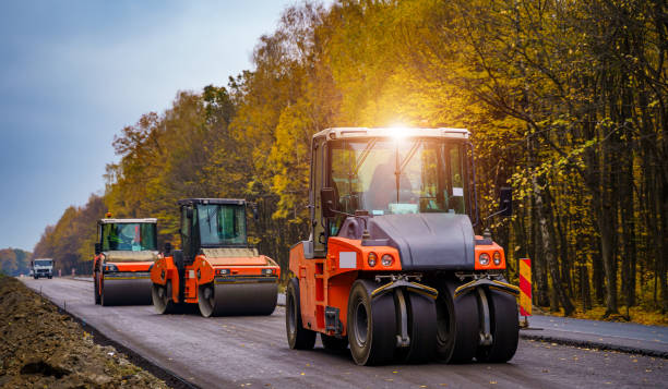 istock Tandem vibration roller compactor working on asphalt pavement, selective focus on road repair. 1219792338