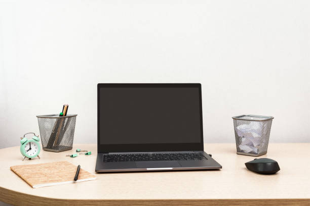 istock Working from home. Open grey laptop for work and clock for control time every day. Workspace for freelancer or under quarantine. Copy space. 1219794954