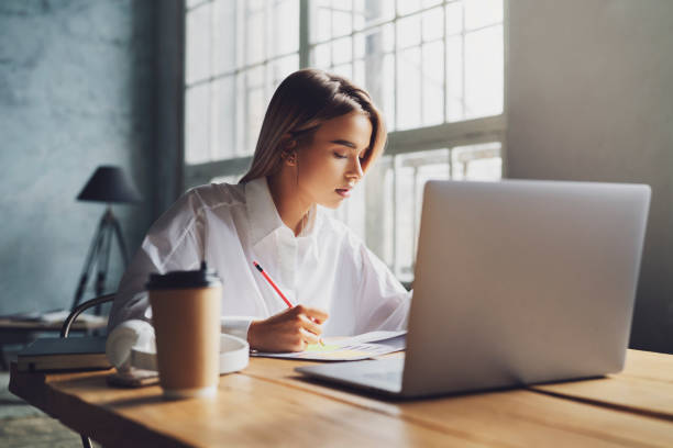 istock Girl sitting concentrated at laptop and studying remotely. Student using online opprotunities for distant education 1219796961