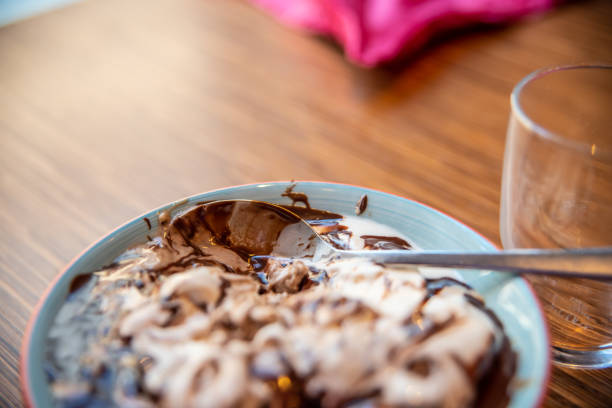 istock Chocolate sauce on ice cream in a bowl on a table. 1219797281