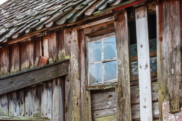 istock Small window on an old abandoned house. 1219797328