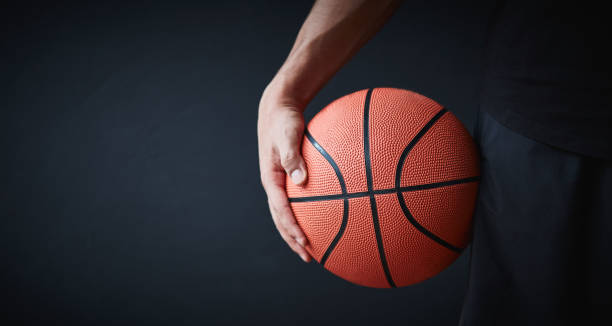 istock Basketball player with ball on black background 1219798129