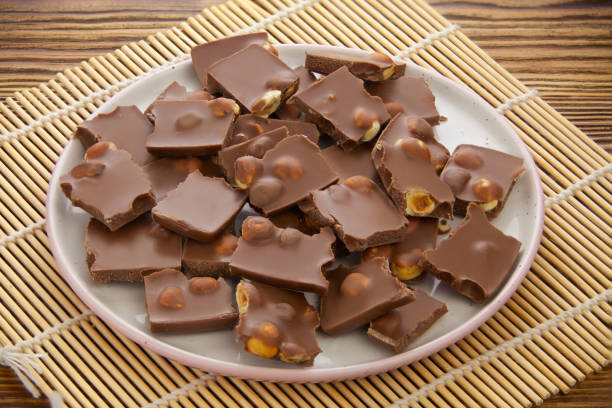 istock Delicious milk chocolate with hazelnuts on wooden background 1219798777