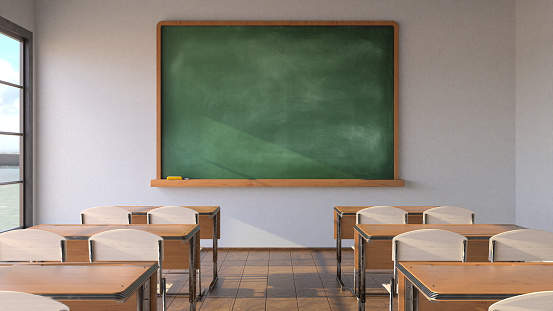 School classroom background - Empty classroom with school blackboard, teacher's desk and raised chair