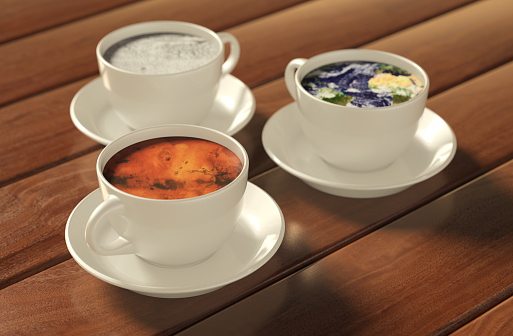 Planets in coffee concept with Earth, Moon and Mars. Earth texture is derived from https://visibleearth.nasa.gov/images/73580/january-blue-marble-next-generation-w-topography-and-bathymetry, Mars texture is derived from https://nasa3d.arc.nasa.gov/detail/mar0kuu2. All the models created in software (Cinema4D)