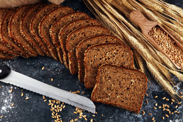 istock Sliced rye bread on cutting board. Whole grain rye bread with seeds on table 1219807681