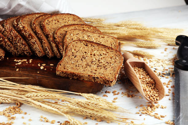istock Sliced rye bread on cutting board. Whole grain rye bread with seeds on table 1219811007