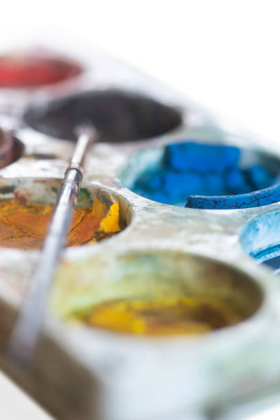 Close up of plastic watercolor plette box with paintbrush