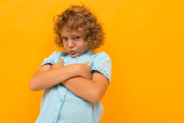 istock offended boy scoffed at the orange wall 1219814399