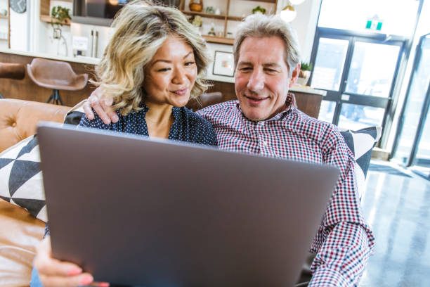 istock Couple Looking at the Laptop Screen Together 1219814592