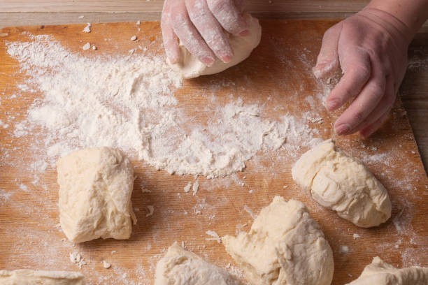 istock Female hands mixing dough in the home kitchen. 1219815057