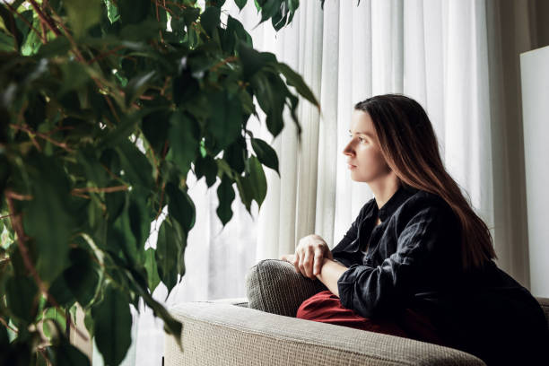 istock Woman looking in the window. 1219815339