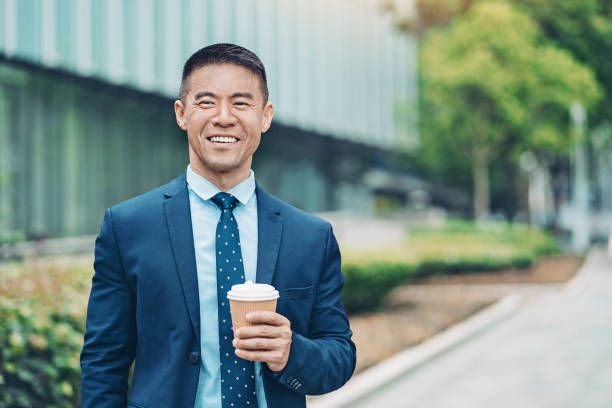 istock Smiling entrepreneur standing by an office building 1219815508