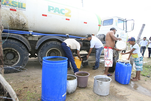santa barbara, bahia / brazil - may 19, 2014: people from the Boquerao community in rural Santa Barbara collect the water transported by tanker truck provided by the Federal Government.