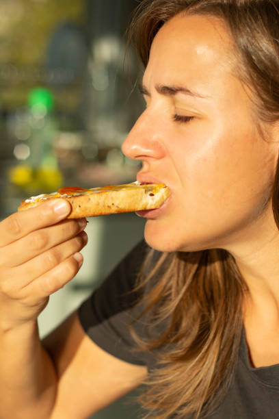 istock woman having breakfast while sunlight shine in her face 1219819042