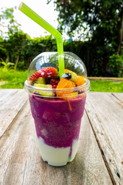istock Juicy mixed fruit smoothy in transparent plastic cup 1219822206