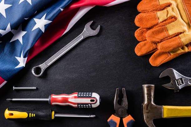 istock Happy Labor day concept. American flag with different construction tools on black table background, with copy space for text. 1219823732