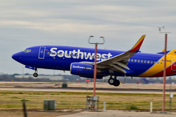 A Southwest Airlines B737 landing An Southwest Airlines B737 landing at Austin Bergstrom International Airport. austin airport stock pictures, royalty-free photos & images