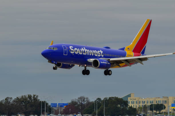 A Southwest Airlines B737 landing An Southwest Airlines B737 landing at Austin Bergstrom International Airport. austin airport stock pictures, royalty-free photos & images