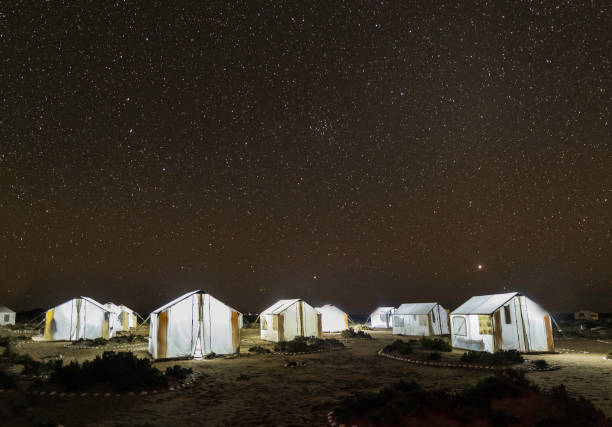 Tents light up at night with stars in the sky. San Ignacio Lagoon, Baja California Sur, Mexico; Tents light up at night with stars in the sky. San Ignacio Lagoon, Baja California Sur, Mexico; el vizcaino biosphere reserve stock pictures, royalty-free photos & images