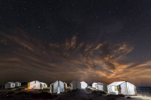 Tents light up at night with stars in the sky. San Ignacio Lagoon, Baja California Sur, Mexico; Tents light up at night with stars in the sky. San Ignacio Lagoon, Baja California Sur, Mexico; el vizcaino biosphere reserve stock pictures, royalty-free photos & images
