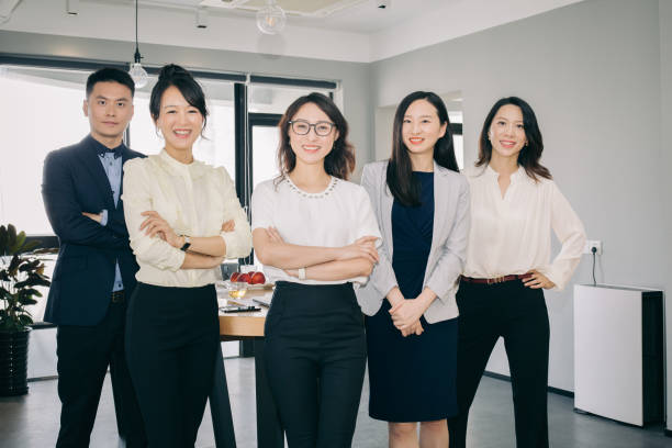 istock Asian business people working together in bright office. 1219829648