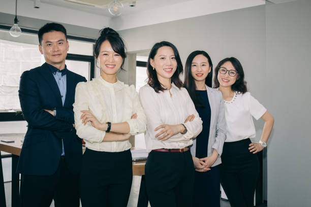 istock Asian business people working together in bright office. 1219829651
