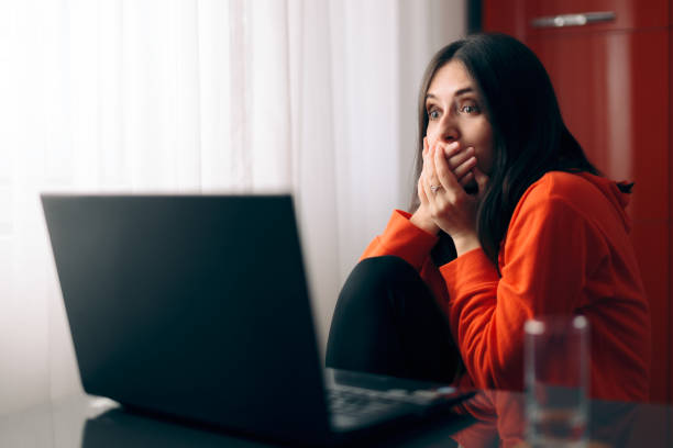 istock Shocked Woman Reading Unbelievable News Online 1219829761