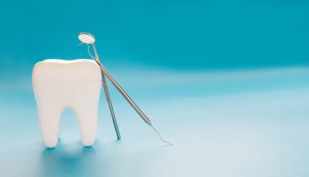 istock Close up big tooth and dentist tool. 1219830408