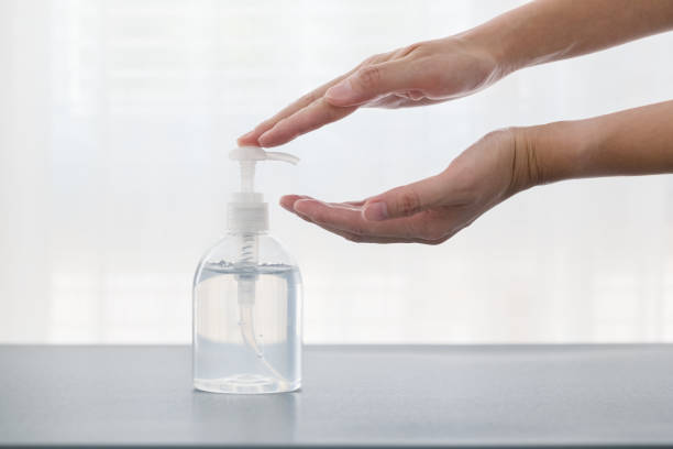 istock hand and alcohol gel bottle 1219831229