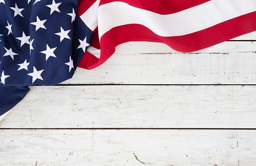 American flag on an old white wood background with textured effect