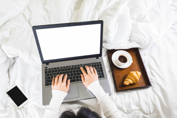 istock Selective focus,top view woman's hand typing on keyboard,croissant,coffee and mobile phone in white bedroom,work online lifestyle,relax at home with coffee ,home working laptop,work from home concept 1219832238