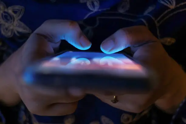 Photo of Woman using her Mobile Phone at night