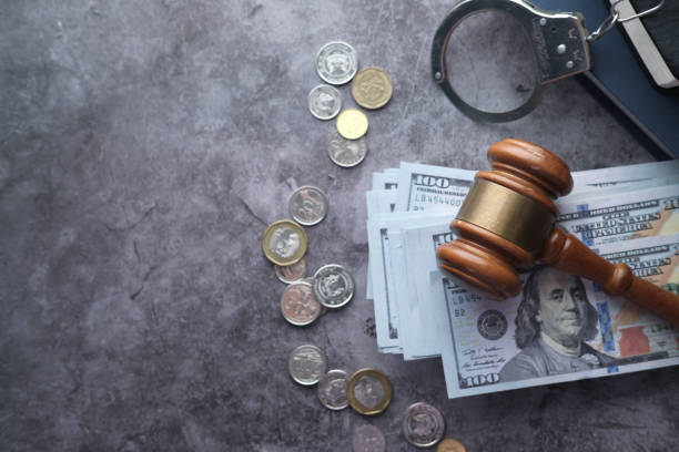 istock high angle view of gavel and cash on table 1219833819