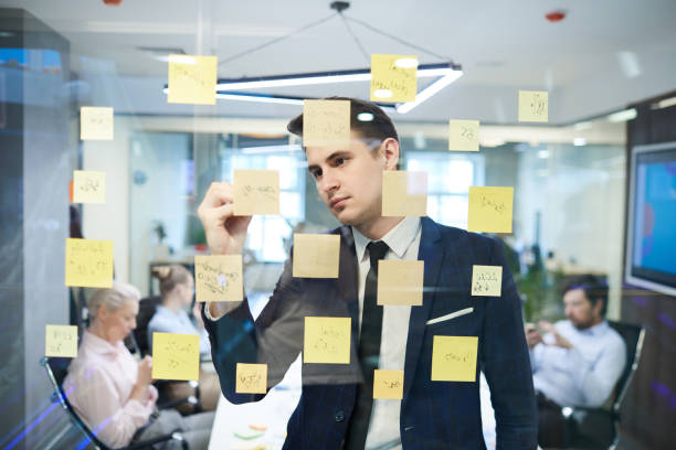 istock Businessman writing  on the wall 1219834749