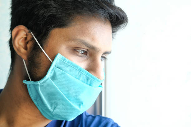 istock a sad man with a mask on his face for antivirus protection 1219835579