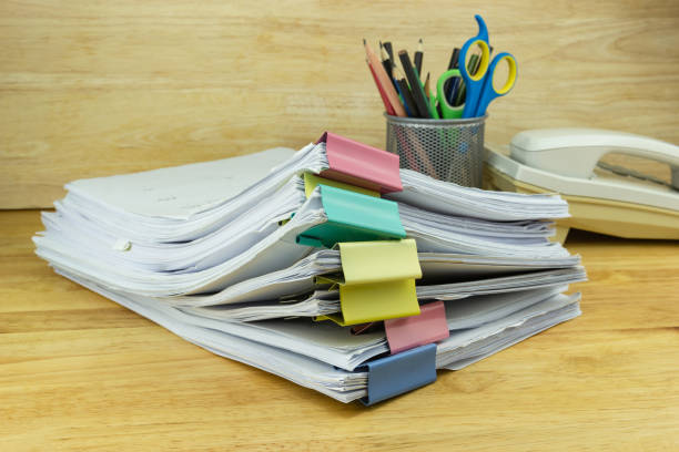 istock file folder and Stack of business report paper file on the table in a work office 1219835609